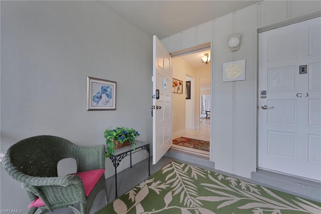 215 Cypress Way East, Unit C4 Naples, FL 34110 - Photo 2 of 15 a living room with furniture and wooden floor