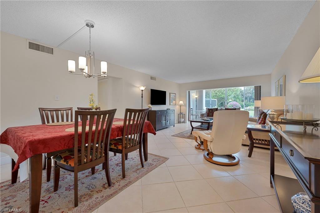 215 Cypress Way East, Unit C4 Naples, FL 34110 - Photo 6 of 15 a view of a dining room with furniture