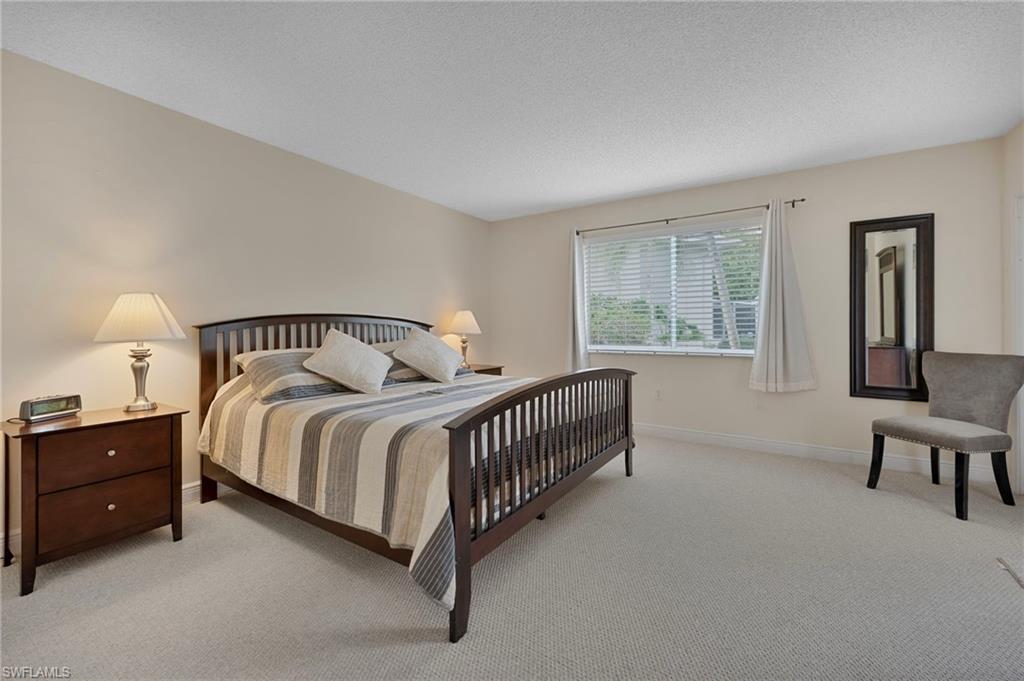 215 Cypress Way East, Unit C4 Naples, FL 34110 - Photo 7 of 15 a bedroom with a bed and window