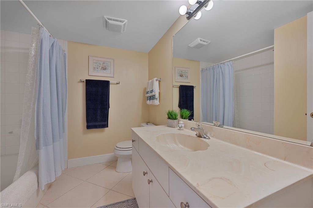 215 Cypress Way East, Unit C4 Naples, FL 34110 - Photo 10 of 15 a bathroom with a sink toilet and shower