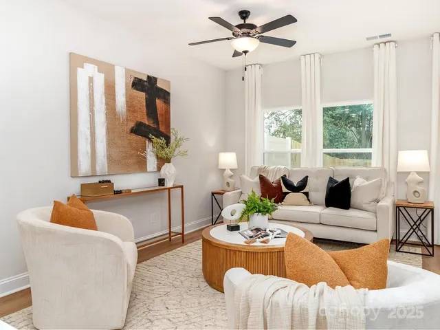 a living room with furniture and a chandelier