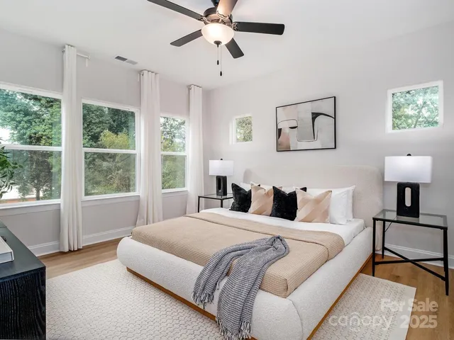 a spacious bedroom with a bed and a window