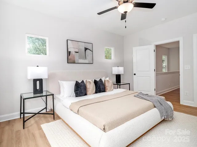 a bedroom with a bed a window and a chandelier