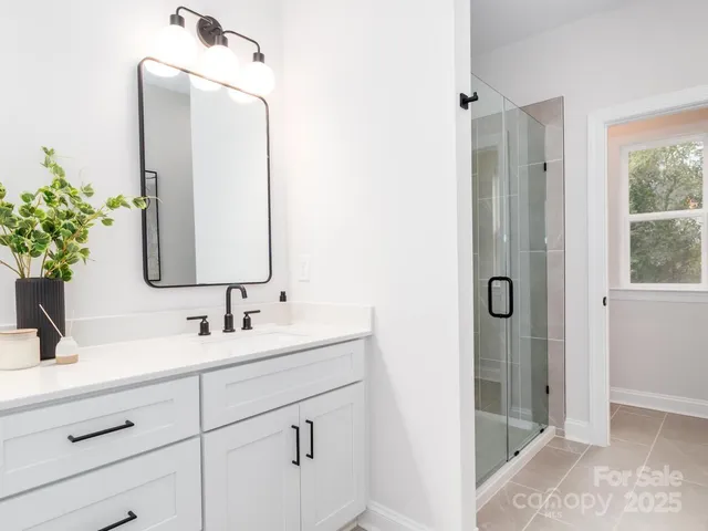 a bathroom with double sink and a mirror