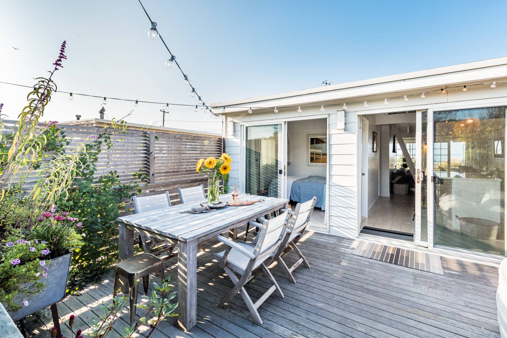 65 Navy Road Montauk, NY 11954 - Photo 14 of 20 a view of a dinning table and chairs in the patio