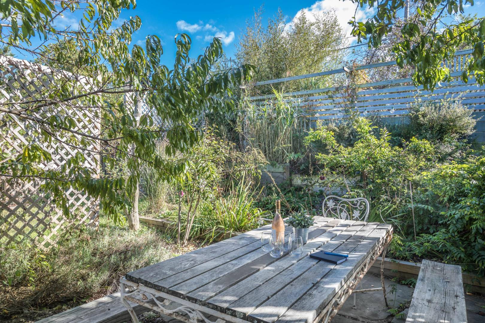 65 Navy Road Montauk, NY 11954 - Photo 17 of 20 a view of a backyard with plants and outdoor seating