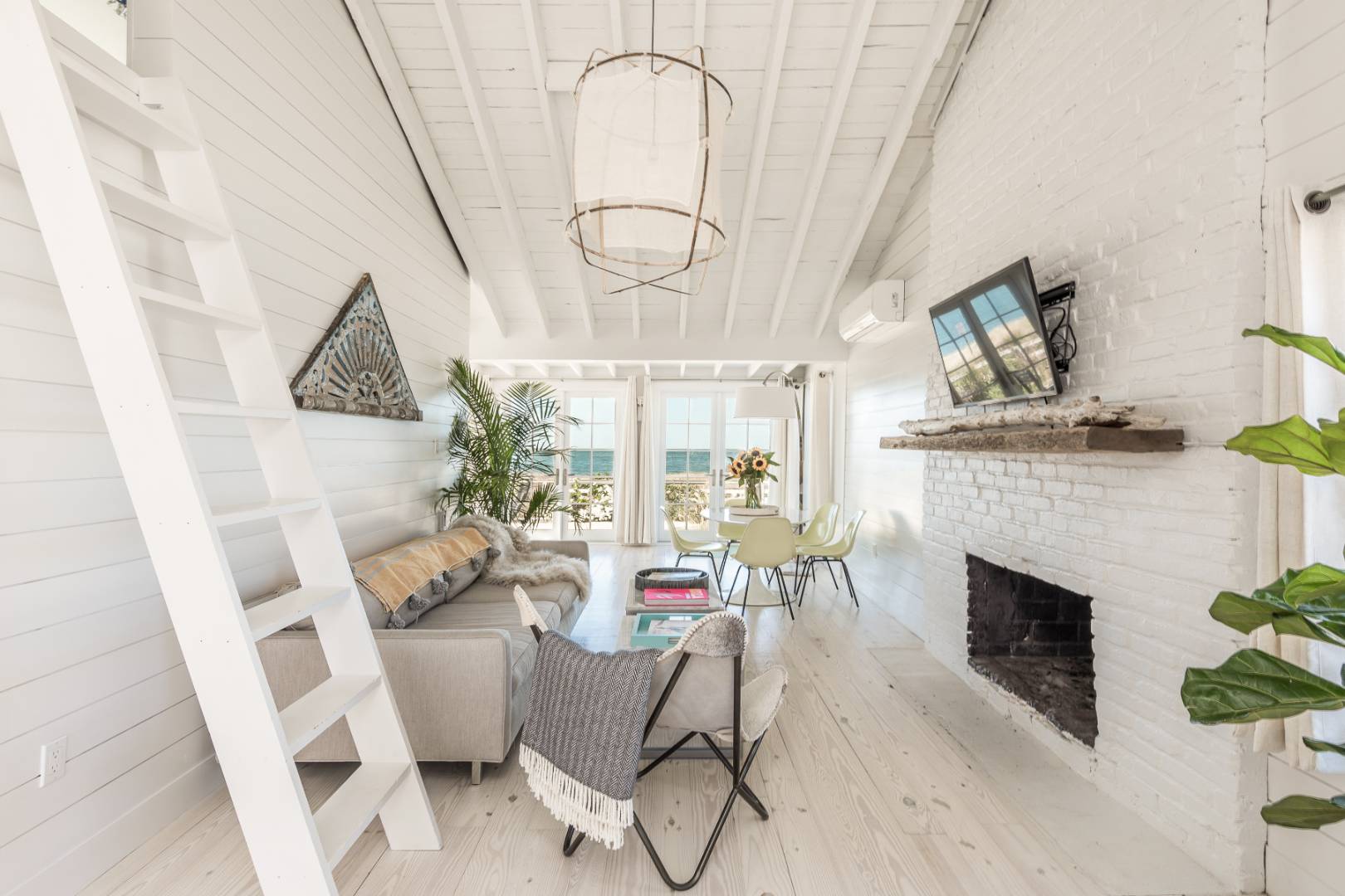 65 Navy Road Montauk, NY 11954 - Photo 6 of 20 a living room with furniture a fireplace and wooden floor