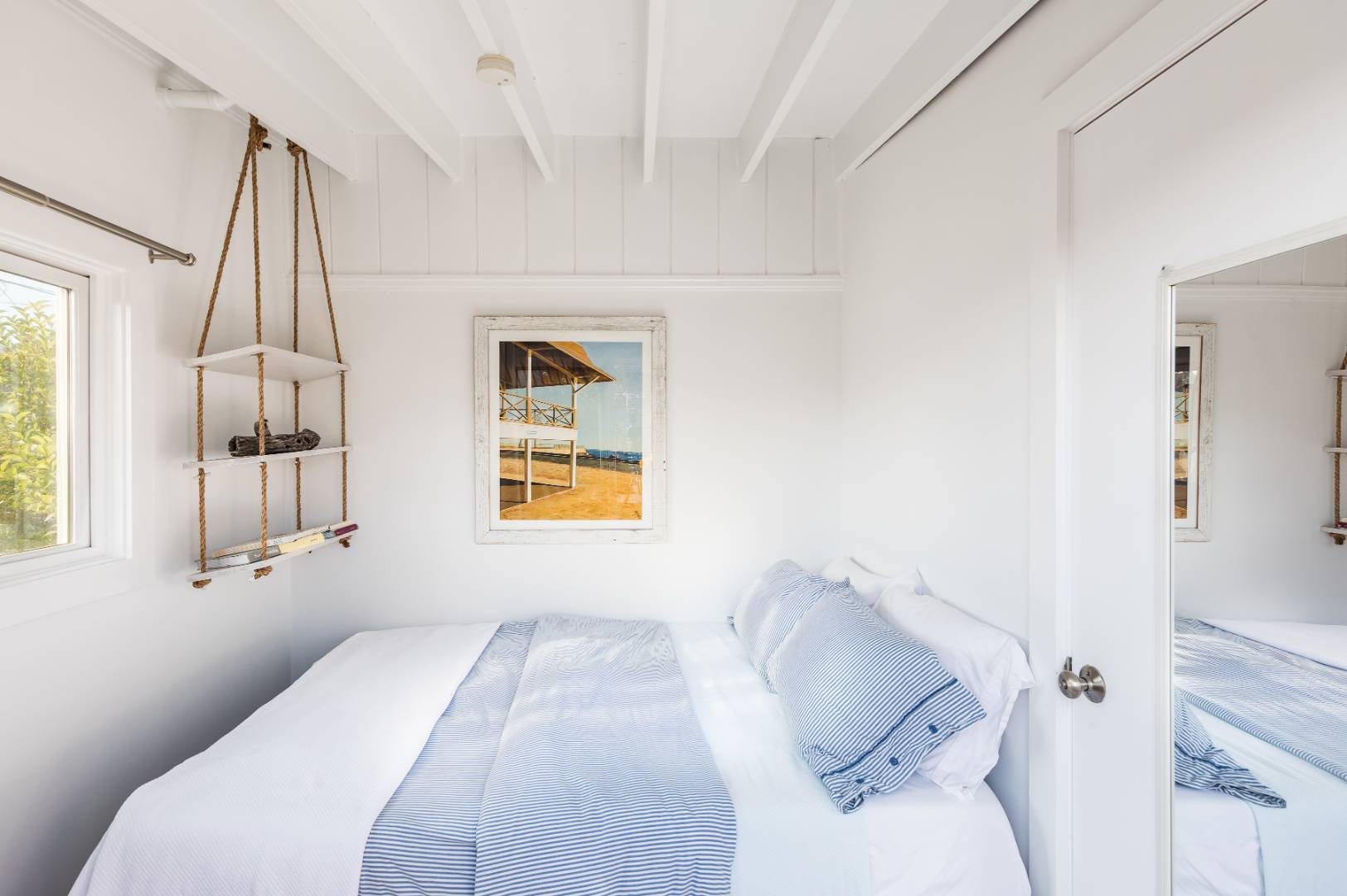 65 Navy Road Montauk, NY 11954 - Photo 8 of 20 a bedroom with a bed and a window