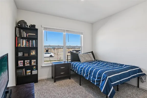a bedroom with a bed furniture and a book shelf