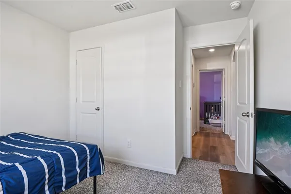 a bedroom with a bed and a view of en suite bathroom