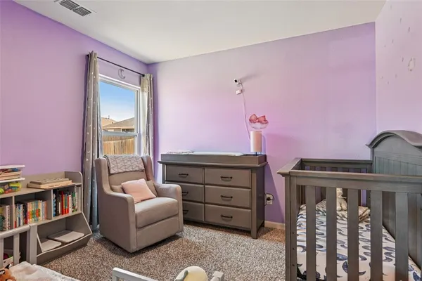 a living room with furniture and a bookshelf