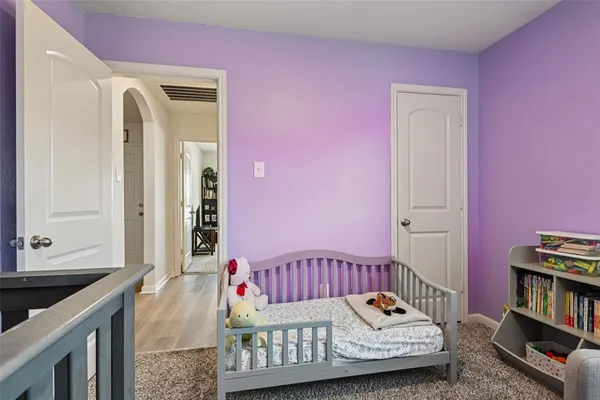 a bedroom with furniture and a book shelf
