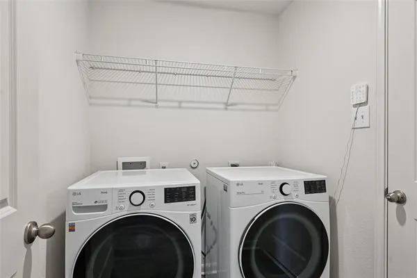 a view of storage and utility room with washer and dryer