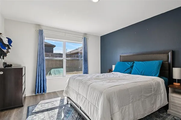 a bedroom with a large bed and a window