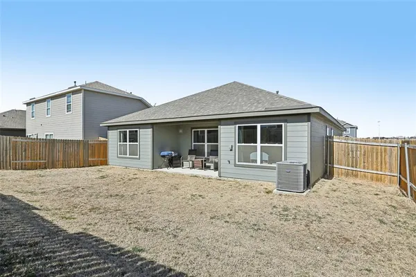 a front view of a house with a garden and patio