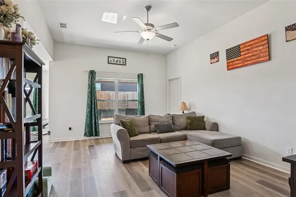 a living room with furniture and a book shelf