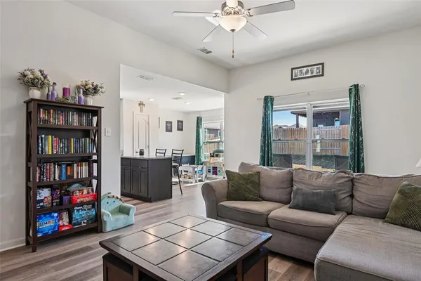 a living room with furniture a bookshelf and a bookshelf