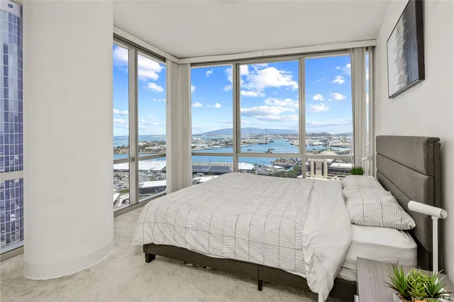 a bed sitting in a bedroom next to a large window