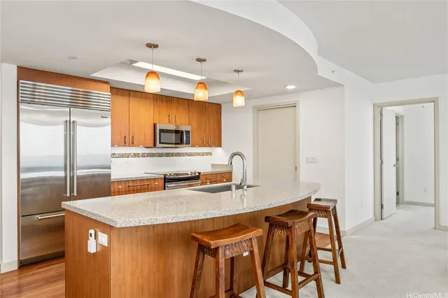 a kitchen with stainless steel appliances granite countertop a sink a stove and a refrigerator