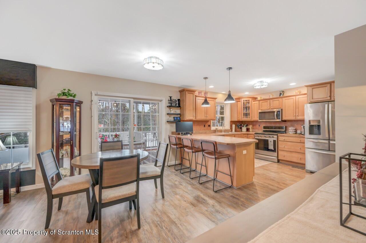 106 Brookview Lane Greentown, PA 18426 - Photo 17 of 59 a dining room with stainless steel appliances kitchen island granite countertop a dining table and chairs