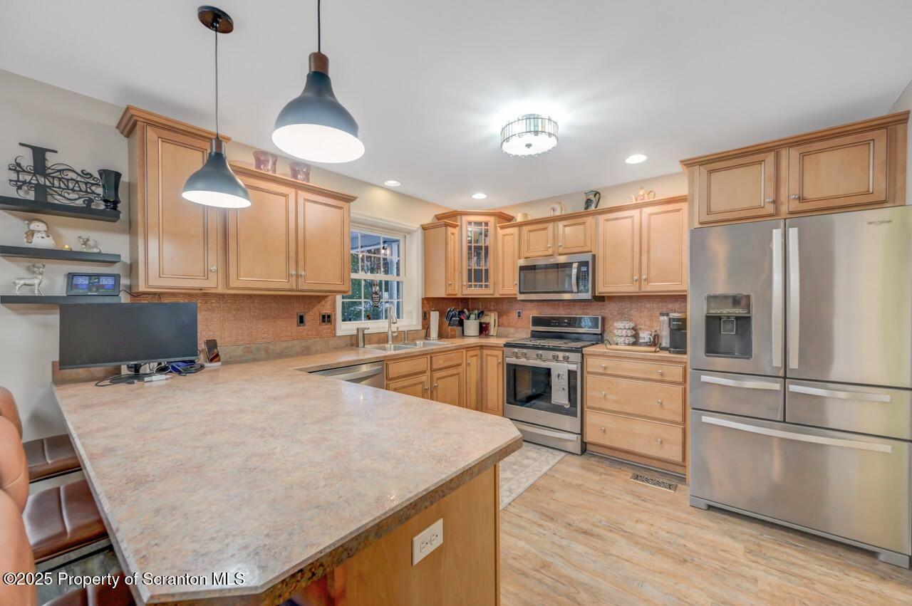106 Brookview Lane Greentown, PA 18426 - Photo 20 of 59 a kitchen with a refrigerator a stove top oven a sink cabinets and wooden floor