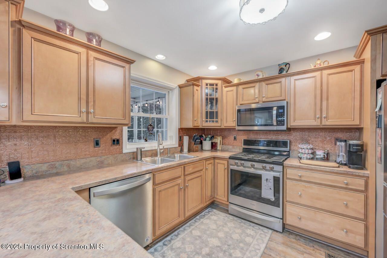106 Brookview Lane Greentown, PA 18426 - Photo 25 of 59 a kitchen with stainless steel appliances granite countertop a stove a sink and a microwave