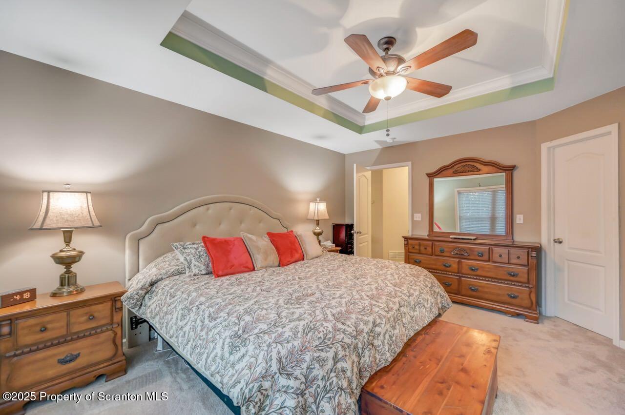 106 Brookview Lane Greentown, PA 18426 - Photo 30 of 59 a bedroom with a large bed and a chandelier