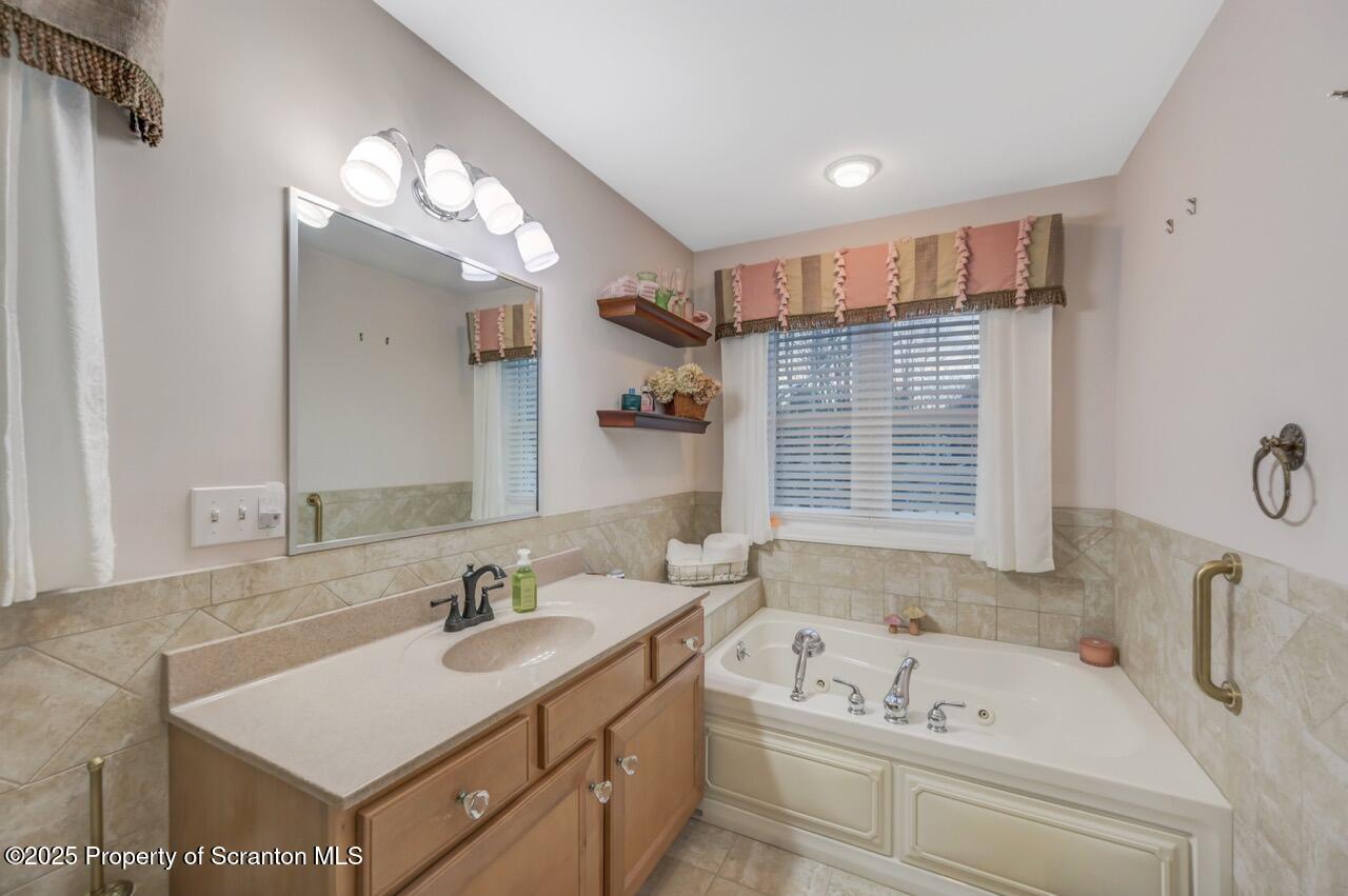 106 Brookview Lane Greentown, PA 18426 - Photo 34 of 59 a bathroom with a tub a sink and a mirror