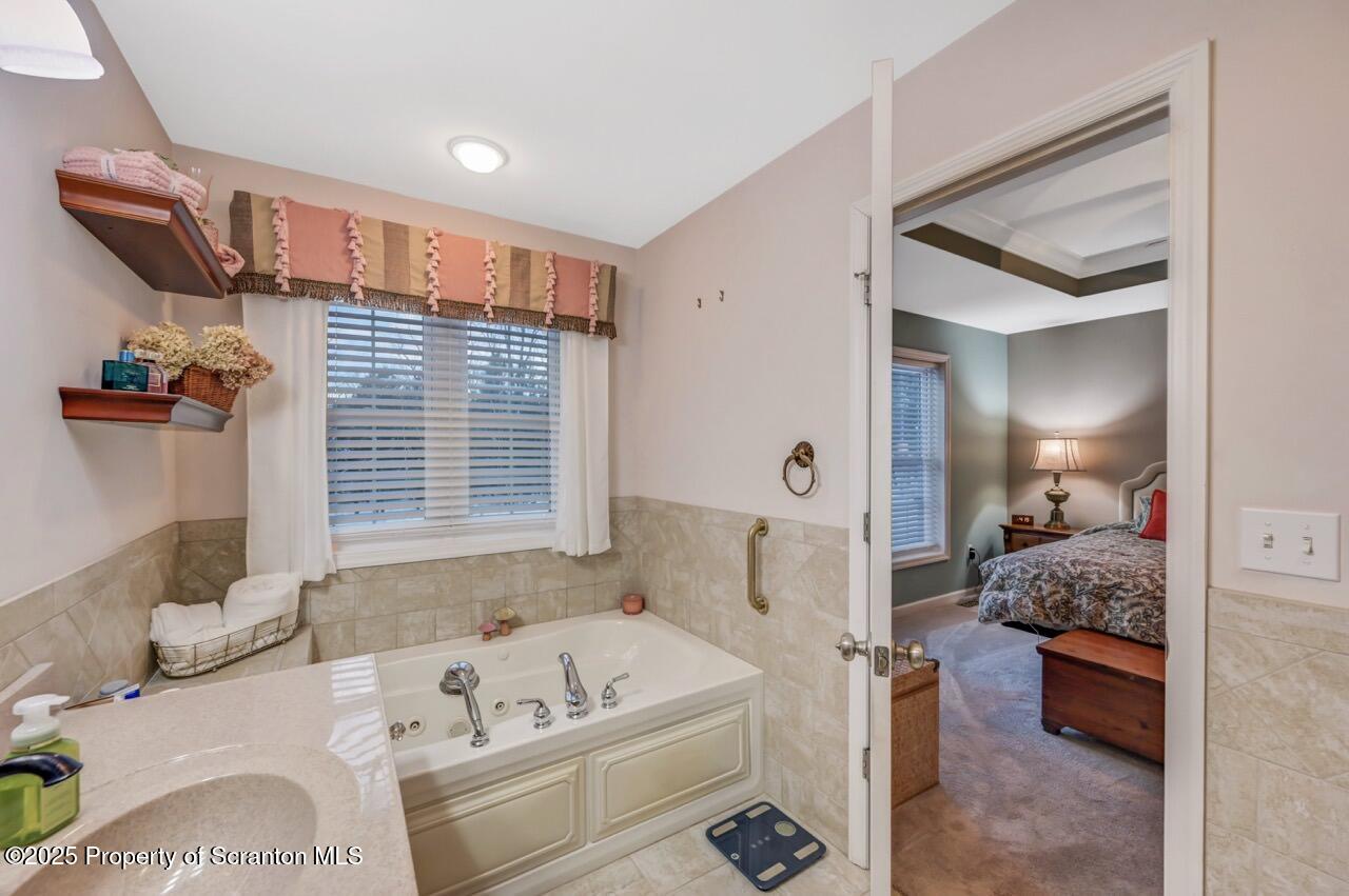 106 Brookview Lane Greentown, PA 18426 - Photo 35 of 59 a bathroom with a tub sink and mirror