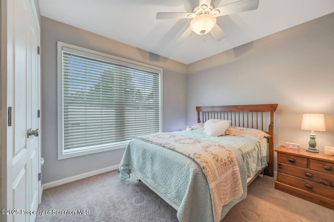 106 Brookview Lane Greentown, PA 18426 - Photo 38 of 59 a bedroom with a bed and a chandelier