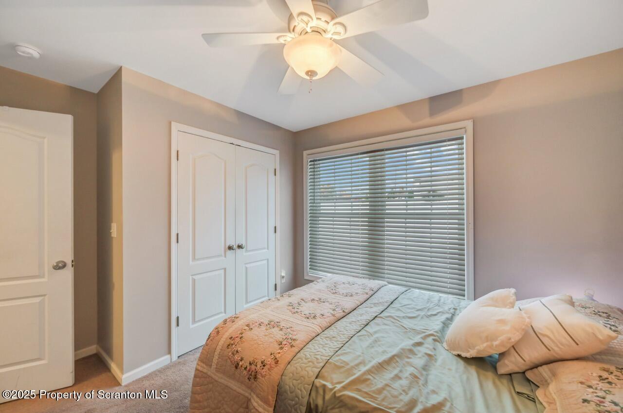 106 Brookview Lane Greentown, PA 18426 - Photo 40 of 59 a bedroom with a bed and a chandelier