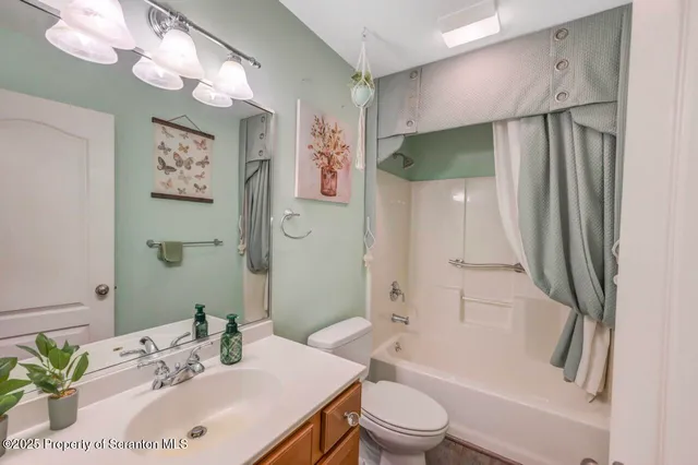 a bathroom with a sink vanity mirror and toilet