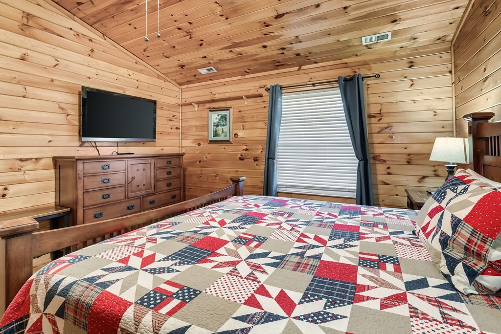 2617 Sharpes Ridge Way Sevierville, TN 37876 - Photo 27 of 43 a bedroom with a bed and flat screen tv