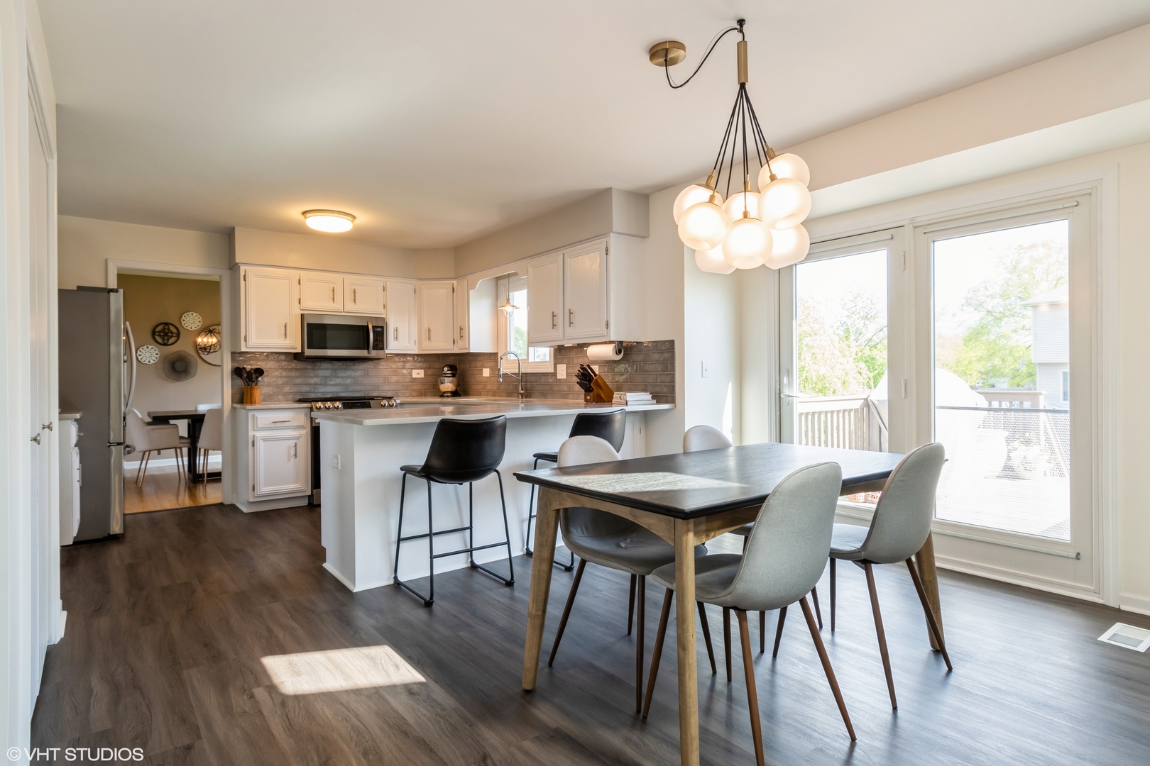 1449 Mesa Drive Bolingbrook, IL 60490 - Photo 10 of 34 a open dining room with stainless steel appliances kitchen island granite countertop a table chairs and a refrigerator
