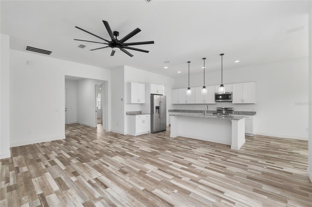 4722 Southeast 25th Loop Ocala, FL 34480 - Photo 14 of 38 a view of kitchen with stainless steel appliances granite countertop cabinets and chandelier