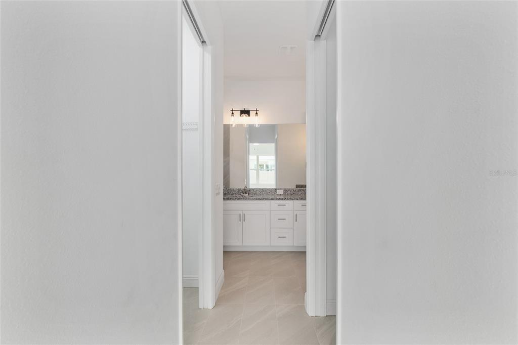 4722 Southeast 25th Loop Ocala, FL 34480 - Photo 22 of 38 a bathroom with a granite countertop sink and mirror