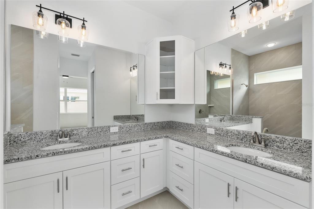 4722 Southeast 25th Loop Ocala, FL 34480 - Photo 23 of 38 a bathroom with a granite countertop double vanity sink and mirror