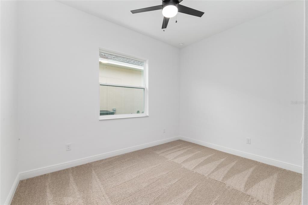 4722 Southeast 25th Loop Ocala, FL 34480 - Photo 28 of 38 an empty room with a window and a ceiling fan