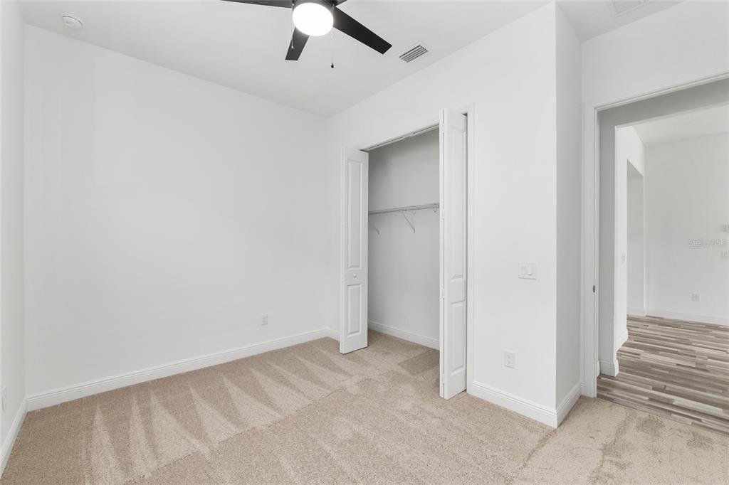 4722 Southeast 25th Loop Ocala, FL 34480 - Photo 29 of 38 an empty room with a ceiling fan