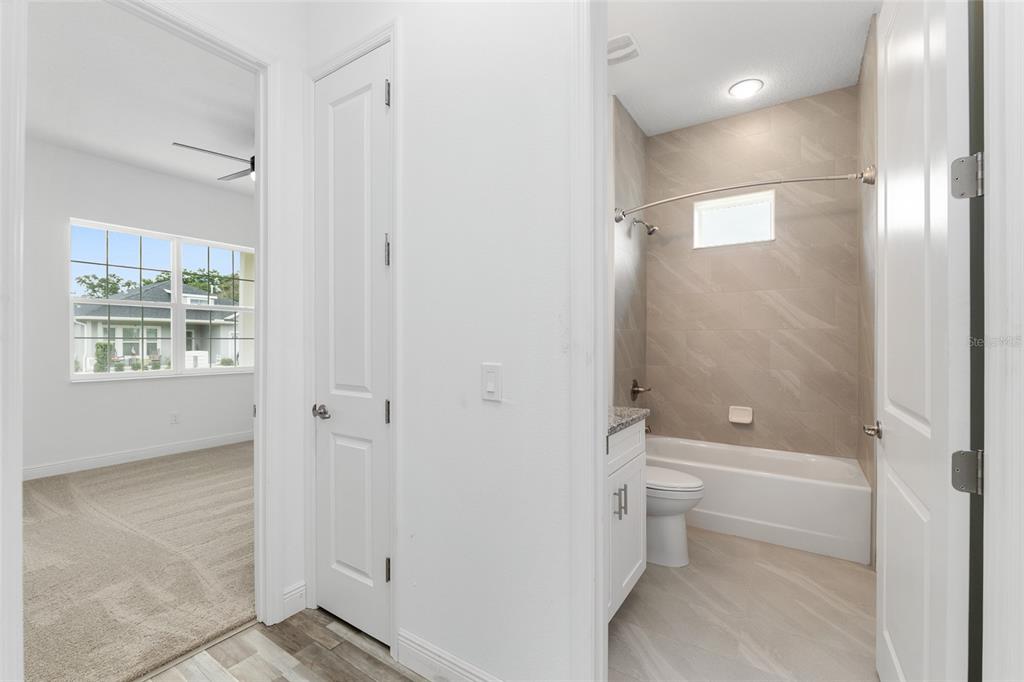 4722 Southeast 25th Loop Ocala, FL 34480 - Photo 30 of 38 a bathroom with a bathtub toilet and shower