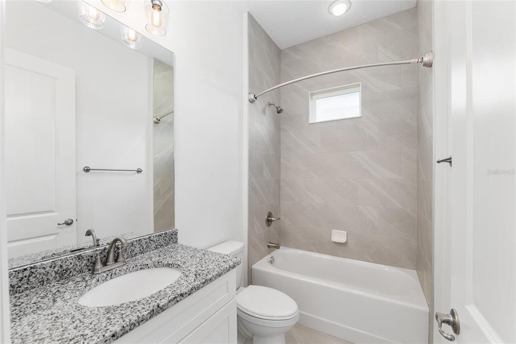 4722 Southeast 25th Loop Ocala, FL 34480 - Photo 31 of 38 a bathroom with a granite countertop sink toilet tub and shower