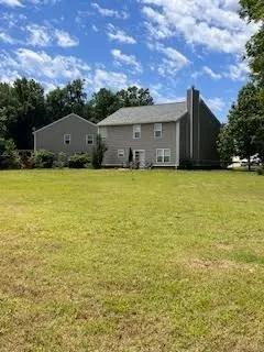 a front view of house with yard and trees
