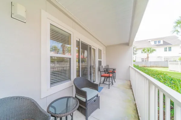 a balcony with chairs and table