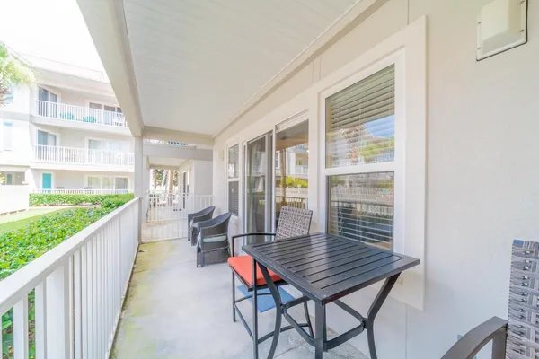 a balcony with chairs and wooden floor
