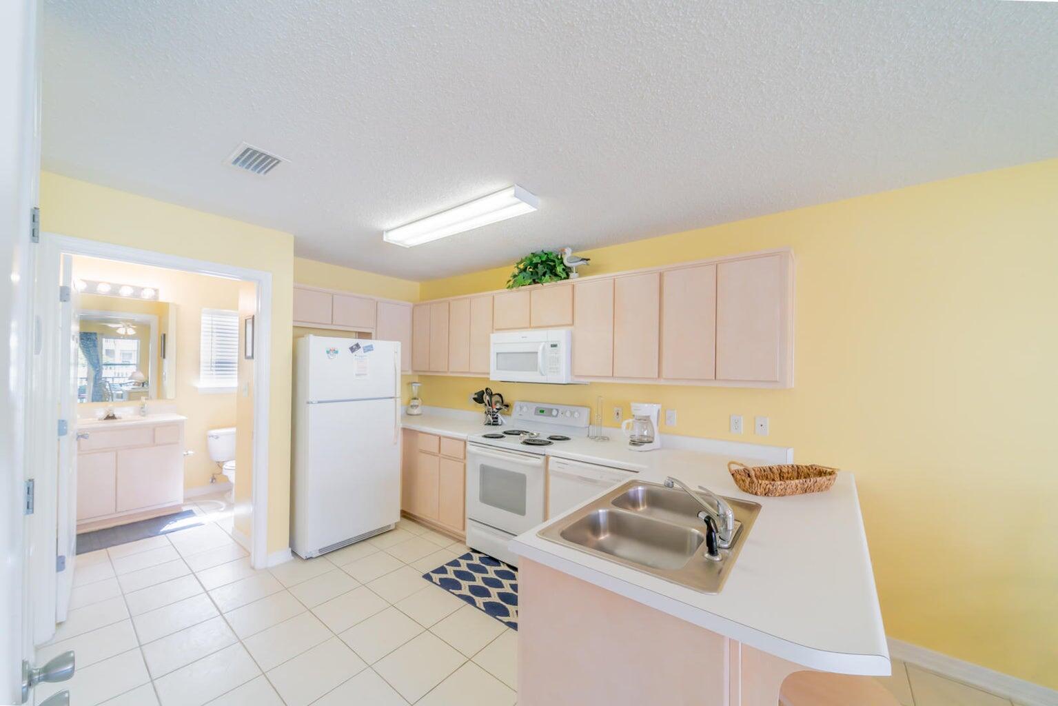 82 Sugar Sand Lane, Unit C3 Santa Rosa Beach, FL 32459 - Photo 7 of 16 a kitchen that has a sink and a refrigerator