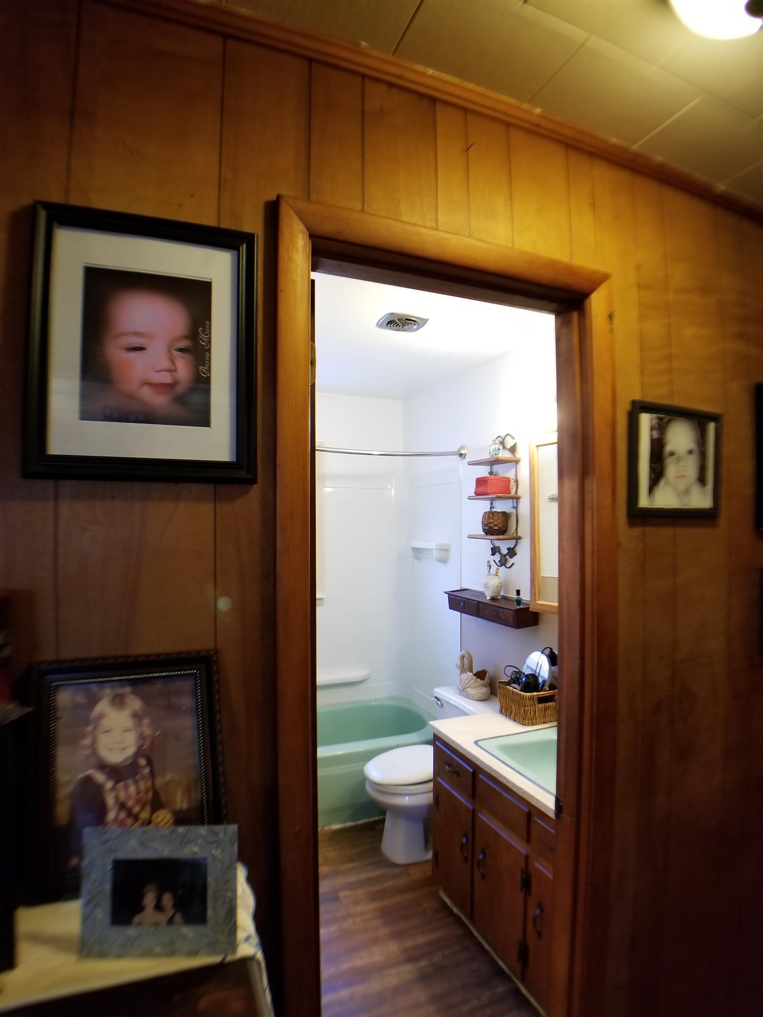 7535 Natchez Trace Road Camden, TN 38320 - Photo 19 of 22 Hallway and Bathroom with Tub/Shower Combo