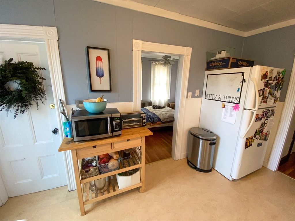 125 Brattle Street, Unit 1 Arlington, MA 02474 - Photo 3 of 10 a room with furniture and a flat screen tv