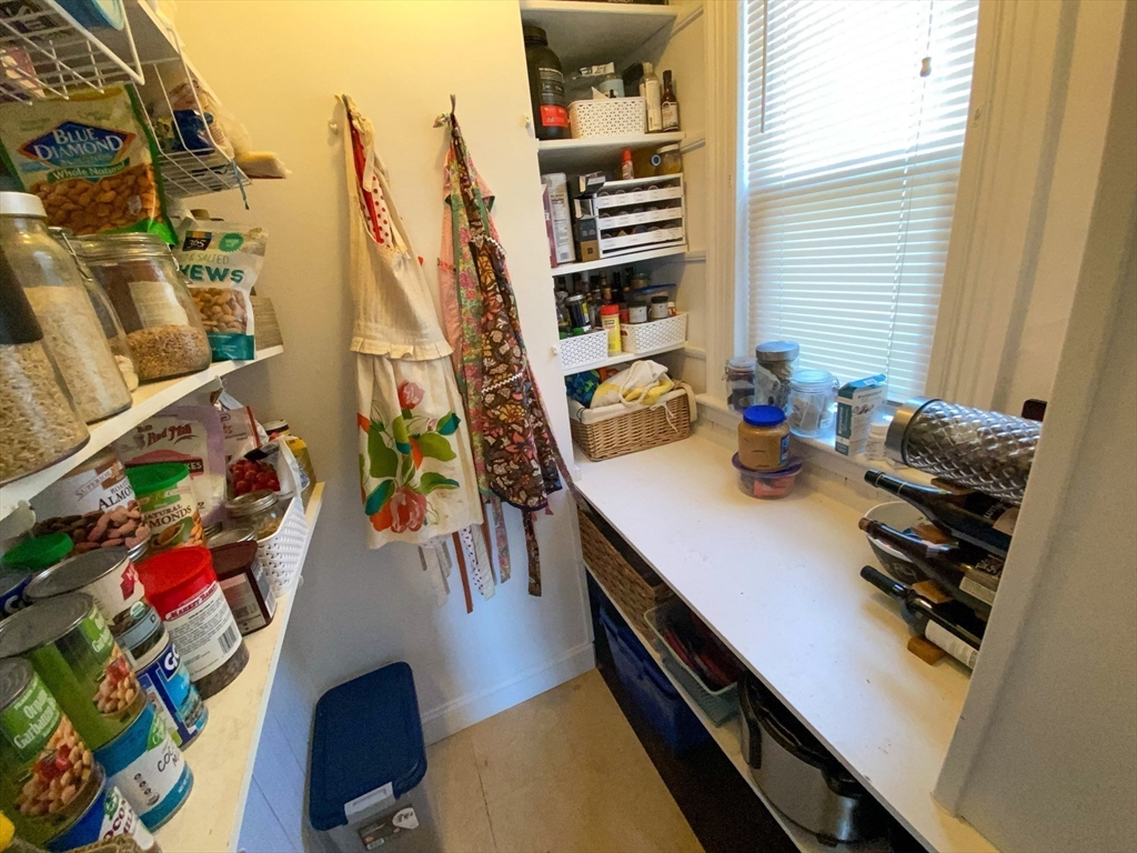 125 Brattle Street, Unit 1 Arlington, MA 02474 - Photo 4 of 10 a view of a living room with furniture and a book shelf