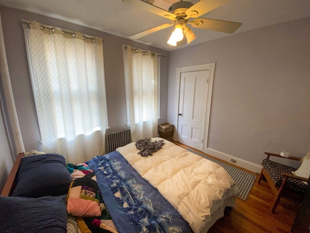 125 Brattle Street, Unit 1 Arlington, MA 02474 - Photo 7 of 10 a bedroom with a bed and a window