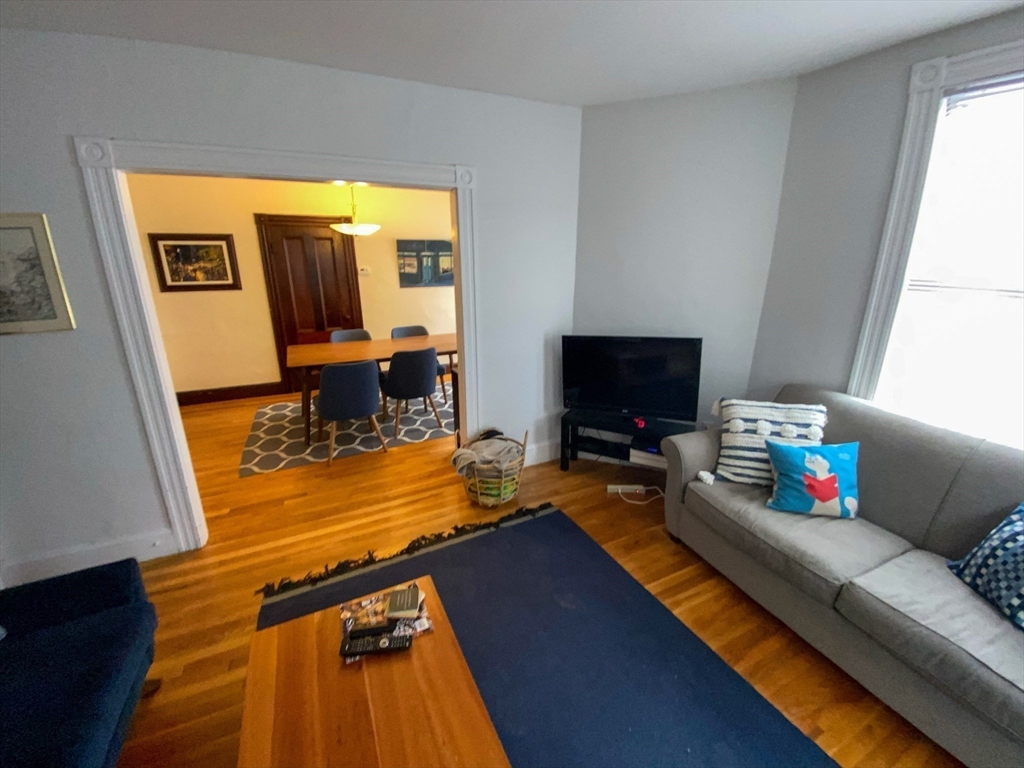 125 Brattle Street, Unit 1 Arlington, MA 02474 - Photo 9 of 10 a living room with furniture and a flat screen tv